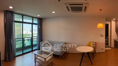 Modern living room with city view and stylish furniture in high-rise apartment.