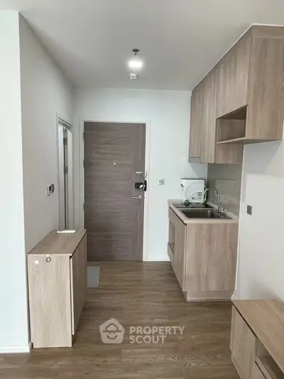 Modern living room with sleek wooden flooring and minimalist design