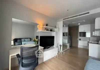 Modern studio apartment with open layout, featuring a cozy living area, sleek kitchen, and stylish decor.