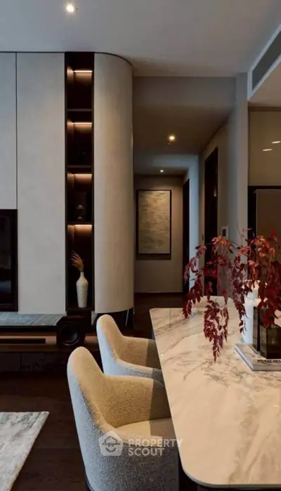 Luxurious modern living room with elegant marble table and plush chairs, perfect for sophisticated gatherings.