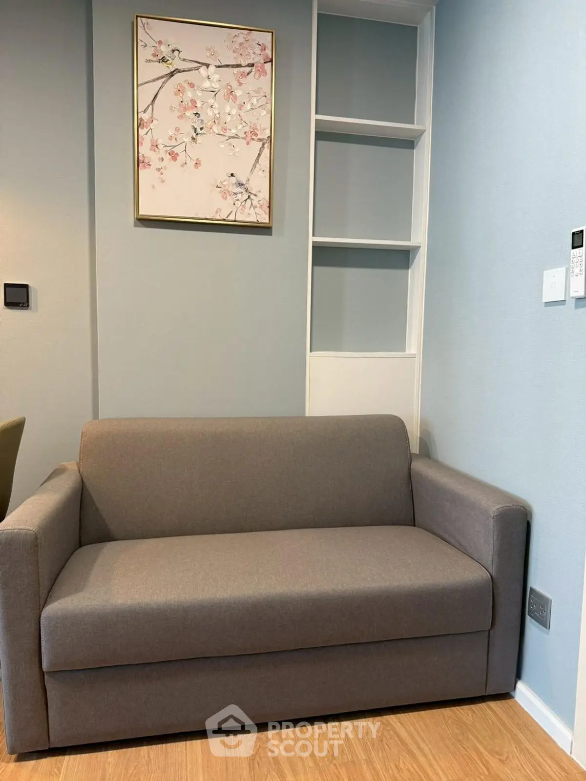 Cozy living room with modern gray sofa and elegant wall art