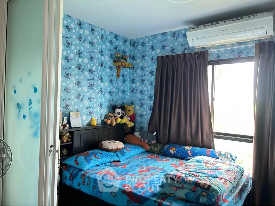 Charming bedroom with playful decor and natural light, perfect for a child's retreat.