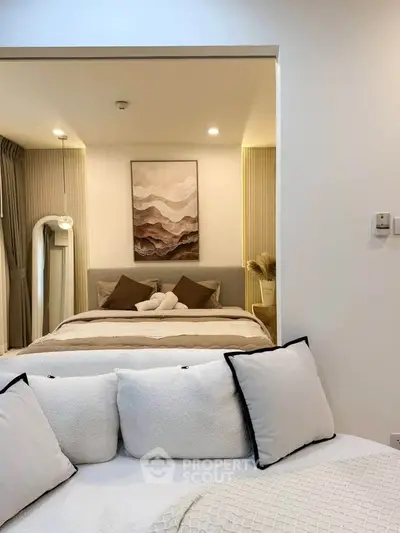 Elegant bedroom with cozy decor and neutral tones, featuring a stylish bed and modern lighting.