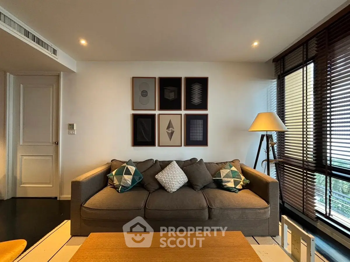 Stylish living room with modern decor and large windows for natural light.