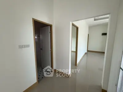 Spacious hallway with modern design and glossy tiled floors in a contemporary home.