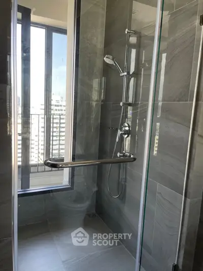 Modern bathroom with sleek shower and city view from window