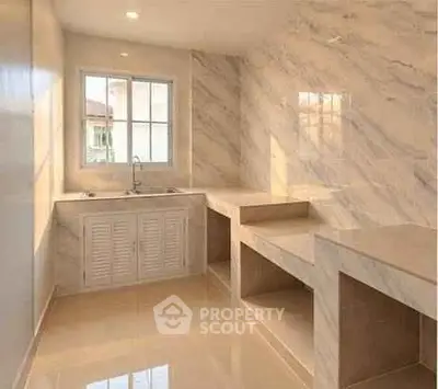 Luxurious marble kitchen with ample counter space and natural light