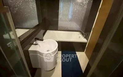 Modern bathroom with sleek design and bathtub in stylish apartment.