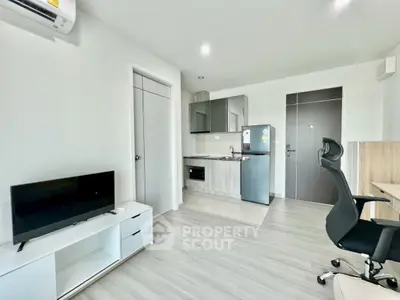 Modern studio apartment with sleek kitchen and cozy living area