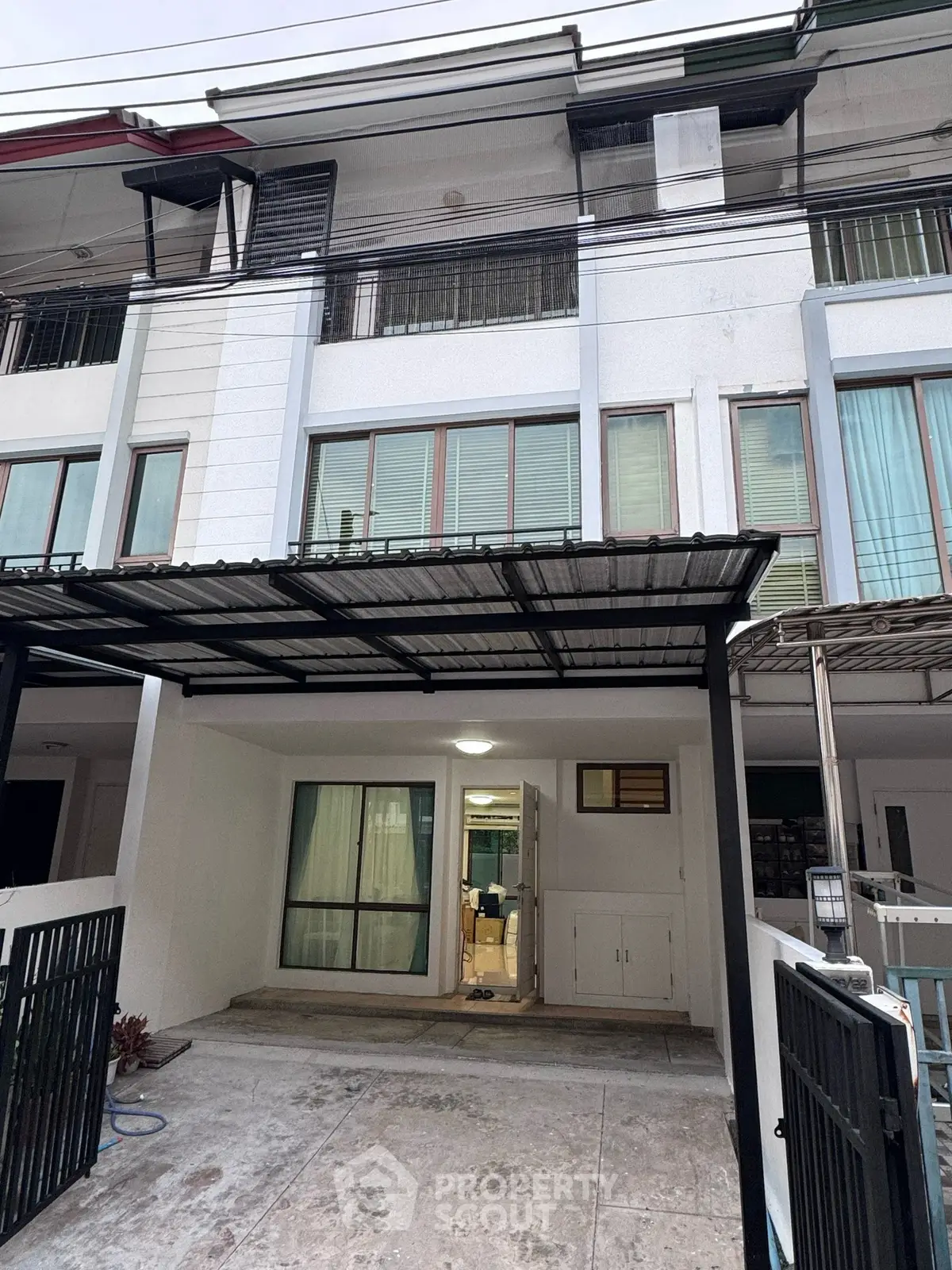 Modern townhouse exterior with covered parking and large windows