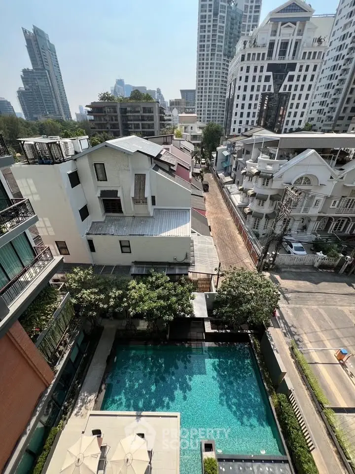 Stunning aerial view of urban residential area with pool and city skyline