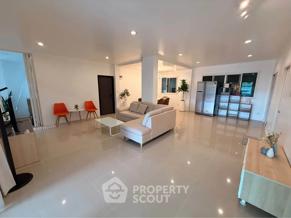 Spacious modern living room with sleek furniture and open layout, perfect for entertaining.