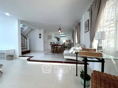 Spacious open-plan living and dining area with elegant decor and natural light.
