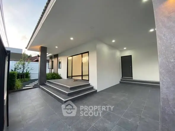 Modern home entrance with sleek design and spacious tiled steps