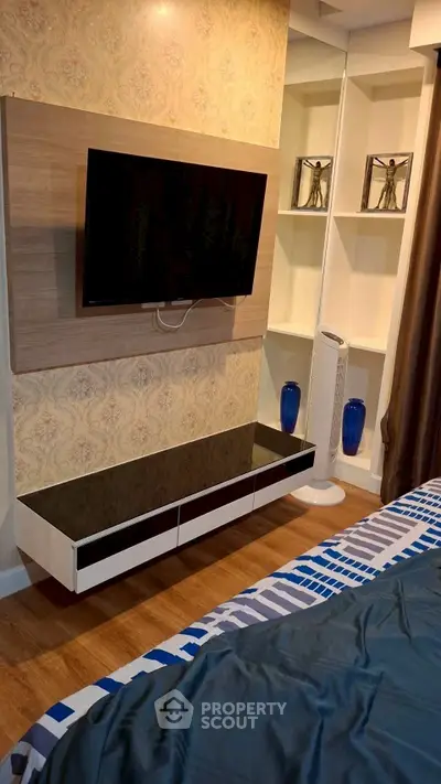 Modern bedroom with wall-mounted TV and stylish decor