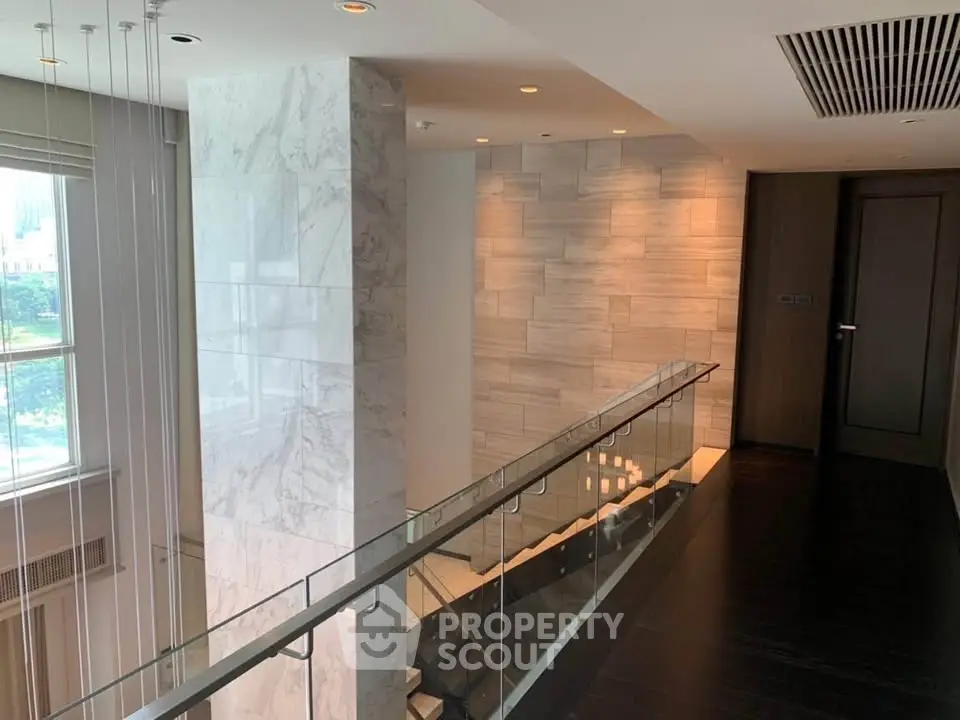 Luxurious modern interior with elegant staircase and marble accents in upscale property