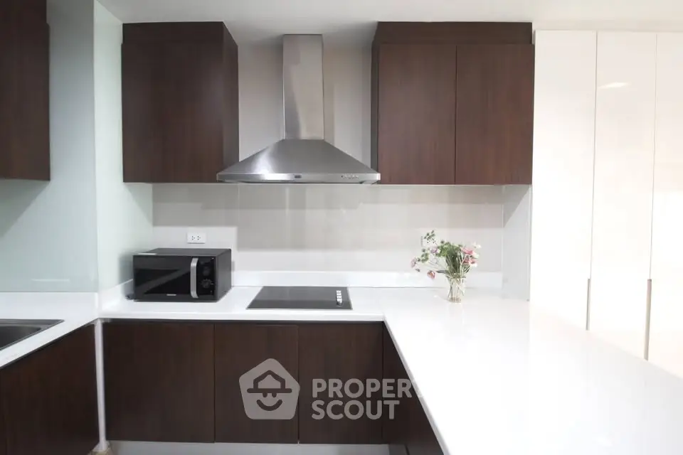 Modern kitchen with sleek cabinetry and stainless steel appliances, featuring a minimalist design and bright ambiance.