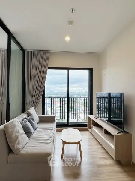 Modern living room with city view, cozy sofa, and sleek TV setup.