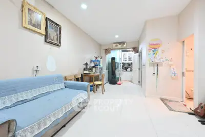 Spacious living room with blue sofa and modern decor in a cozy apartment.