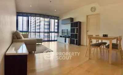 Spacious modern living room with large windows and elegant furniture