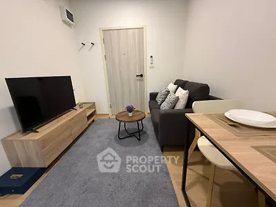Cozy living room with modern furniture and dining area in a stylish apartment.