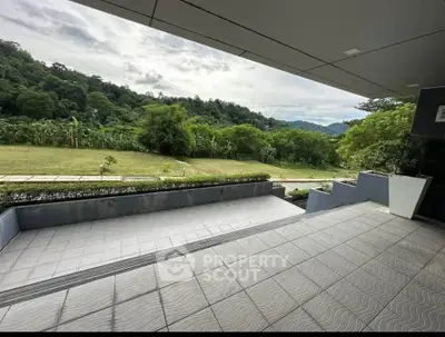 Spacious balcony with scenic green view in modern property