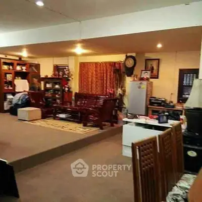 Spacious living room with elegant wooden furniture and cozy ambiance.