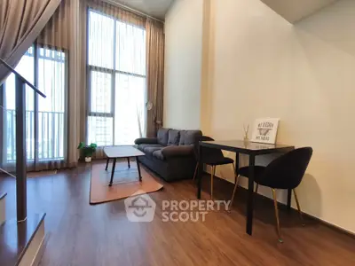 Modern living room with high ceilings and stylish furniture in a contemporary apartment.