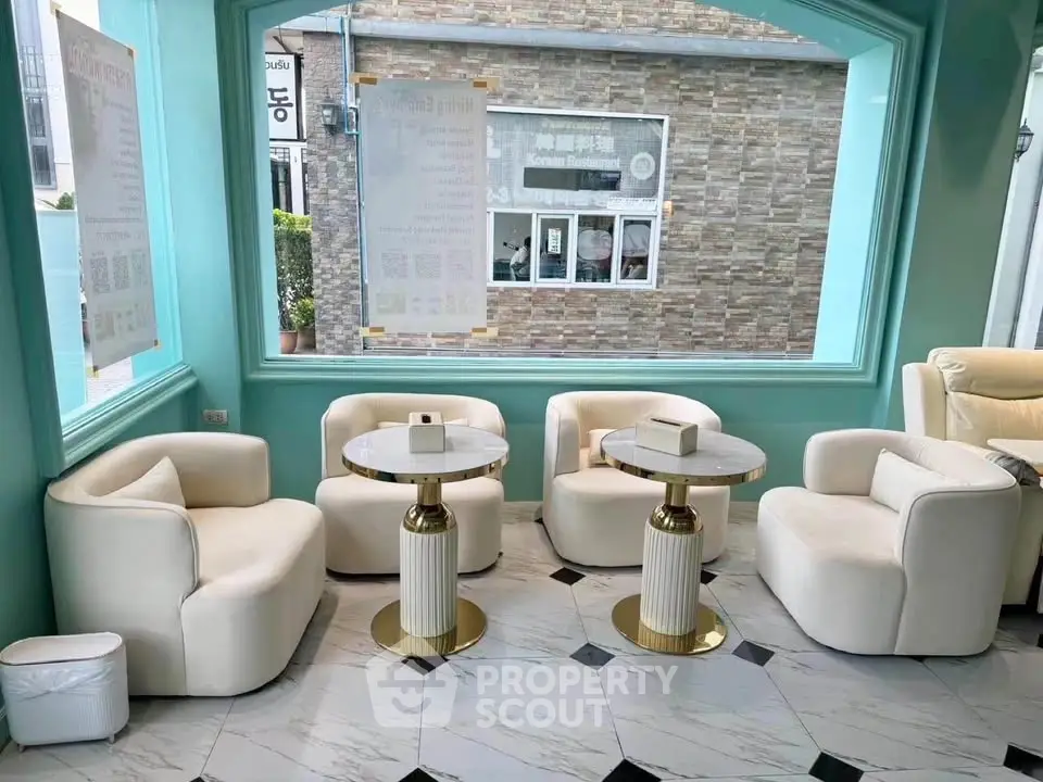 Elegant modern living room with plush white seating and marble tables