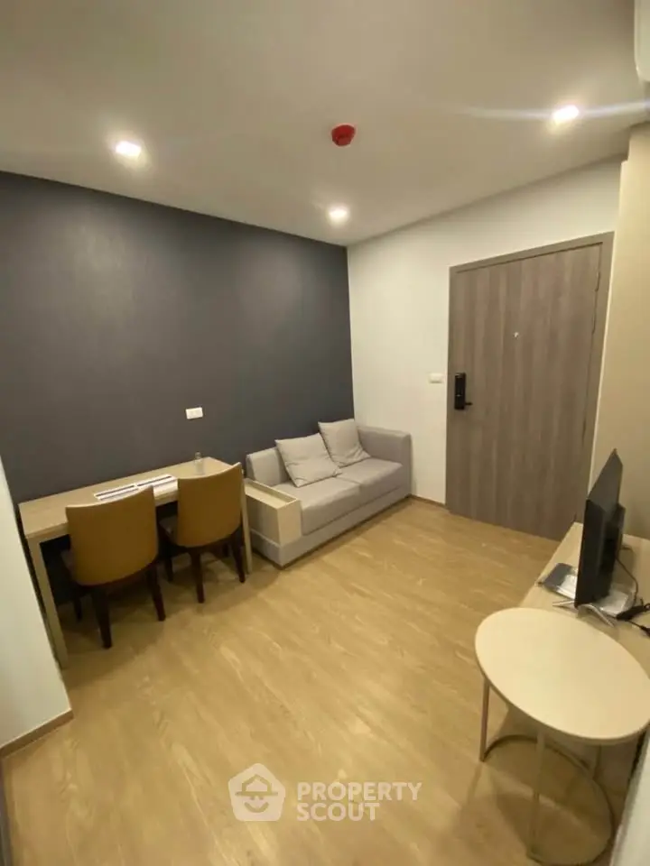 Modern living room with cozy sofa and dining area, perfect for urban living.