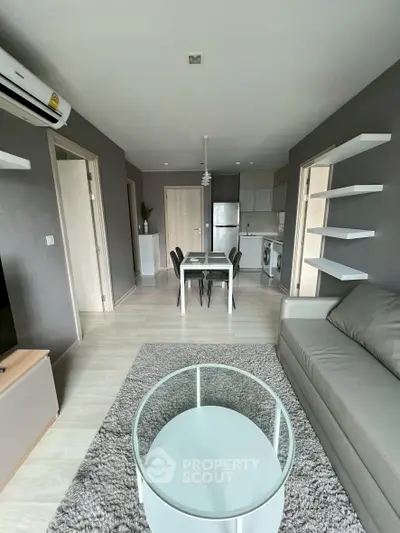 Modern living room with open kitchen layout and stylish furniture