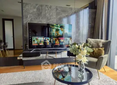 Modern living room with large TV and stylish decor