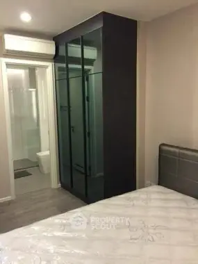 Modern bedroom with ensuite bathroom and sleek wardrobe design.