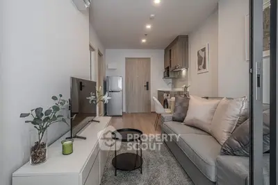 Modern living room with sleek furniture and open kitchen layout