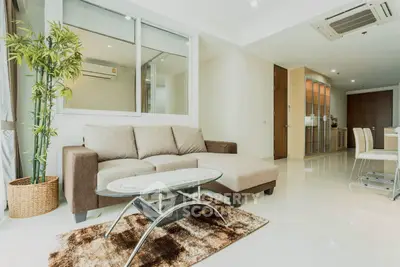 Spacious modern living room with elegant furniture and natural light, perfect for relaxation and entertaining.