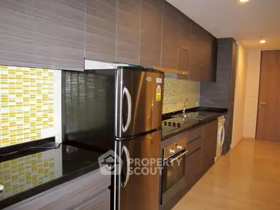 Modern kitchen with sleek cabinets, stainless steel appliances, and vibrant backsplash.