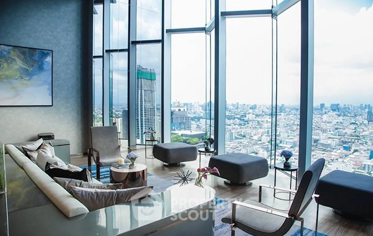 Luxurious high-rise living room with panoramic city views and modern decor.