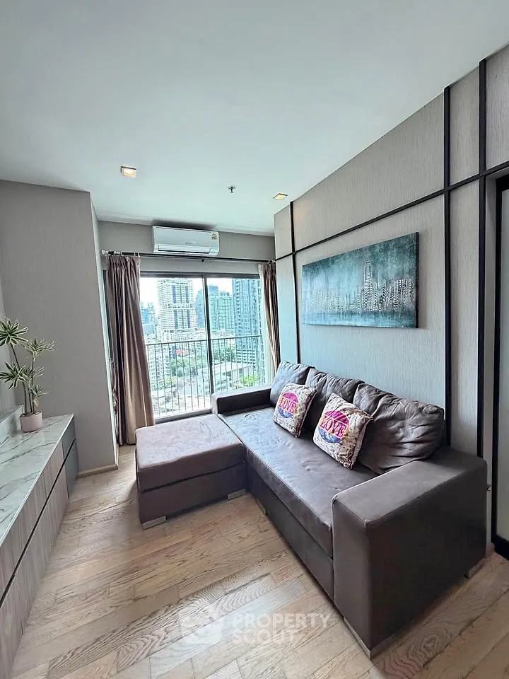 Modern living room with city view, featuring a cozy sofa and stylish decor.