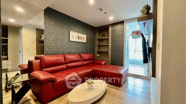 Modern living room with red leather sectional sofa and stylish decor