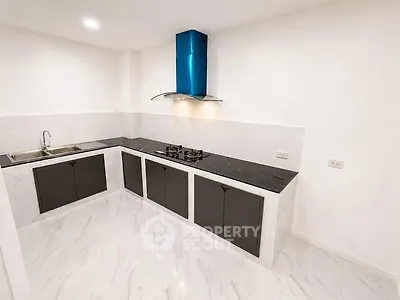 Modern kitchen with sleek black countertops and gas stove