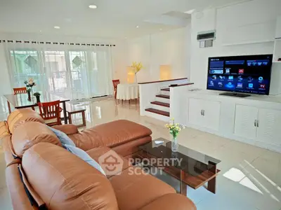 Spacious living room with leather sofa and modern entertainment system