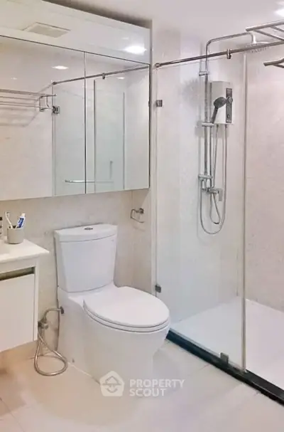 Modern bathroom with glass shower enclosure and sleek fixtures