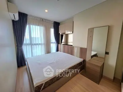 Modern bedroom with large window and stylish decor