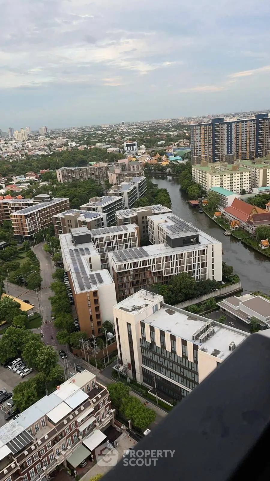 Stunning cityscape view from high-rise building overlooking river and modern architecture.