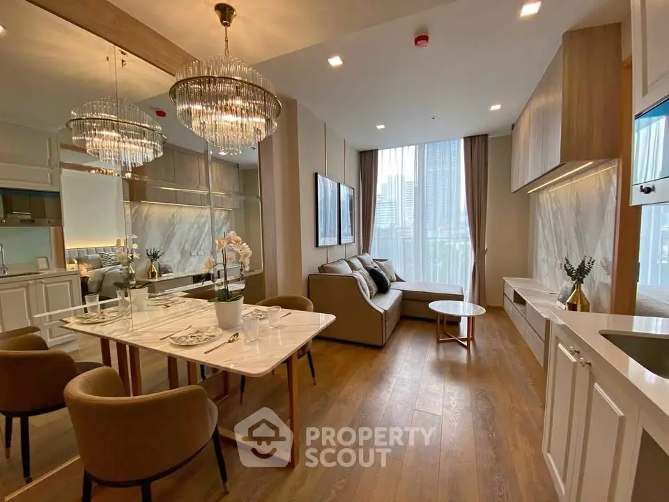 Luxurious modern living room with elegant dining area and city view, featuring chic chandeliers and stylish decor.
