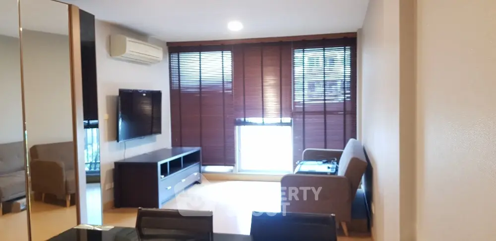 Modern living room with sleek furniture and large windows