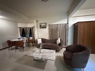 Elegant living room with modern furniture and marble coffee table, perfect for stylish urban living.
