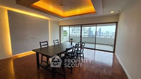 Spacious dining area with city view and elegant lighting, perfect for gatherings.