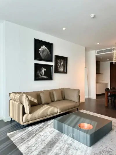 Modern living room with stylish decor and elegant furniture, featuring a cozy sofa and artistic wall art.