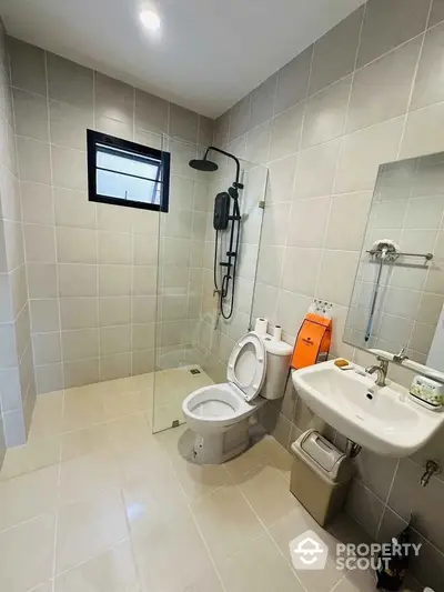 Modern bathroom with glass shower and sleek fixtures in contemporary home